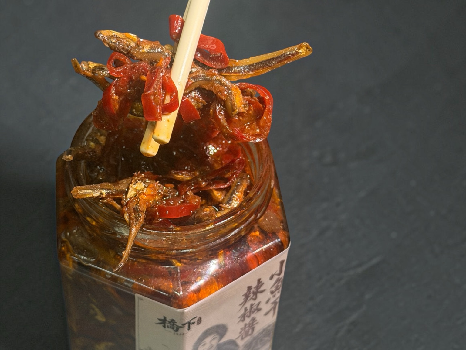 筷子夾起油亮的小魚乾辣椒醬